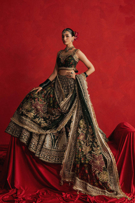 Mohsin Naveed Ranjha Gul-e-Khaas dark green Indian silk lehenga choli featuring a floral printed sleeveless choli with golden embroidery along the neckline and straps, paired with a lehenga layered with appliqués, block-printed motifs, gota patti, mirror work, hand embroidery, and spade-inspired geometric patterns with an ornate golden threadwork hemline, complete with an organza dupatta blooming with printed florals, gota patti, adda work, embroidered borders, kiran trims, and delicate tassels, perfect for