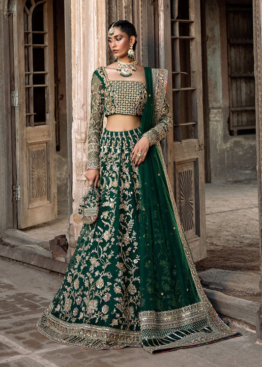 Kanwal Malik Sukhan bottle green net lehenga choli featuring an intricately embellished choli and flowing lehenga with a floral jaal design in vibrant orange and pink accents, enhanced with gold, gotta, and silver embellishments, complete with a matching net dupatta with an embellished border, perfect for weddings and festive occasions.