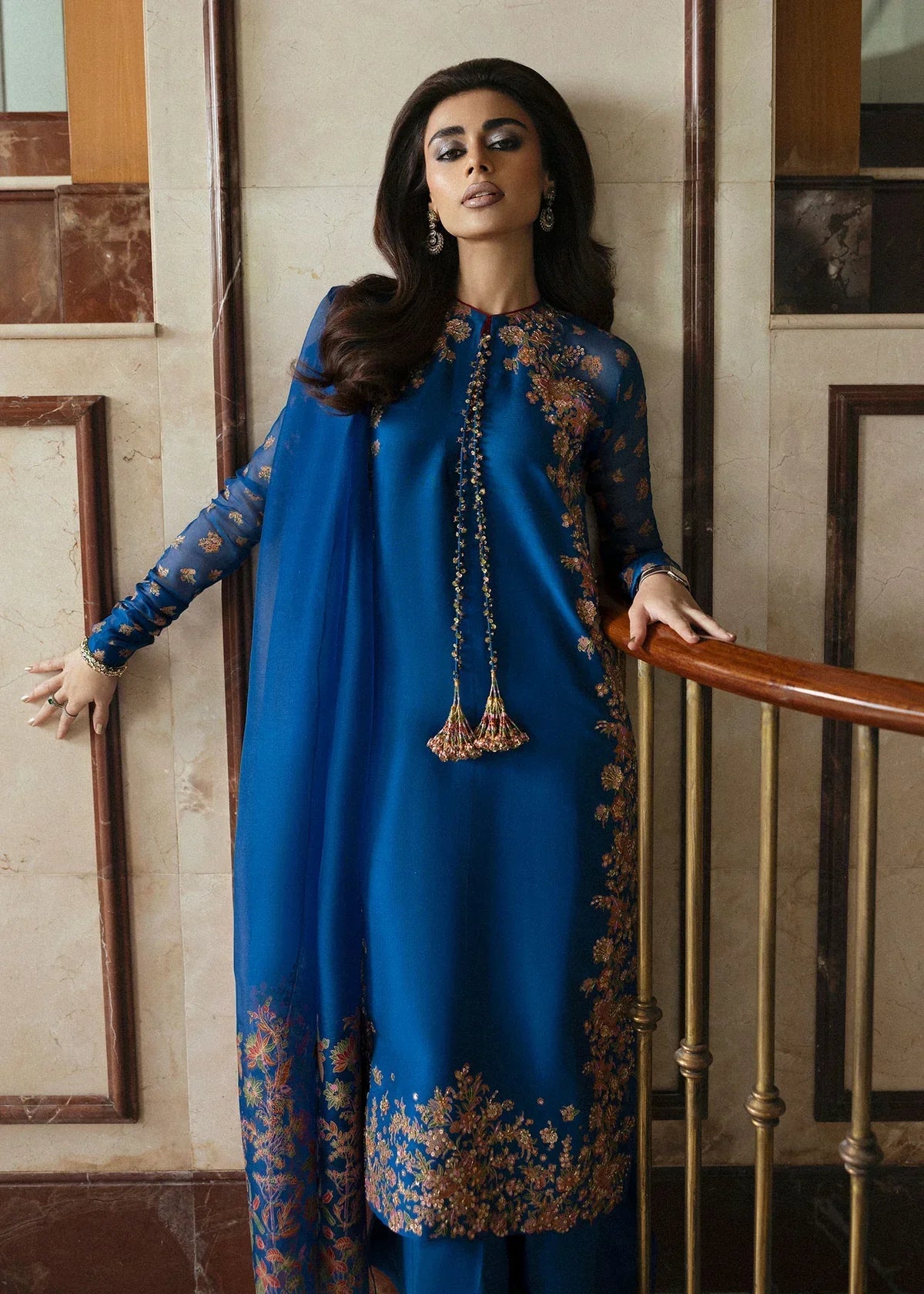 Hussain Rehar Serene teal blue raw silk shirt featuring vibrant screen-printed details with delicate embellishments and chic raglan sleeves in sheer screen-printed organza, paired with plain culottes and a matching screen-printed dupatta, perfect for festive gatherings and semi-formal events.