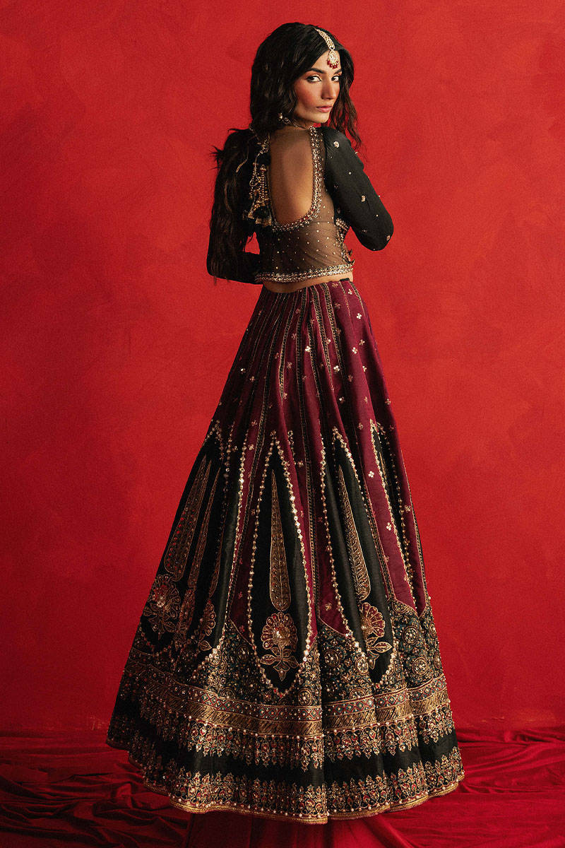 Mohsin Naveed Ranjha Dil Raas black Indian silk lehenga choli featuring a full-sleeved choli with metallic and silk thread embroidery in star-like patterns, paired with a lehenga in deep maroon fading to black with embroidered cypress trees, palmette motifs, mirrorwork, sequins, and golden thread detailing, finished with maroon and gold layered borders, complete with a lightweight organza dupatta featuring maroon and gold floral sprays, gota pati, and adda work, perfect for bridal wear and formal celebratio