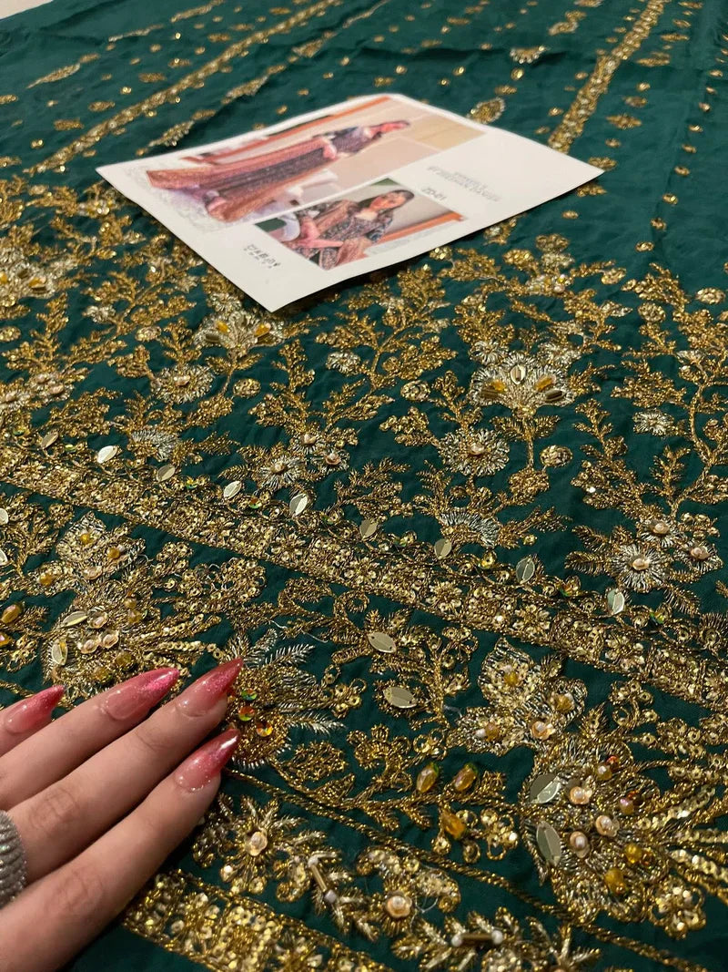 Haris Shakeel ZD-01 emerald heirloom ensemble in deep emerald green featuring intricate antique gold embroidery with dense hand-embellished motifs on a long flowing silhouette, paired with a richly detailed dupatta with heavy borders and delicate shimmer, perfect for bridal elegance and timeless sophistication.