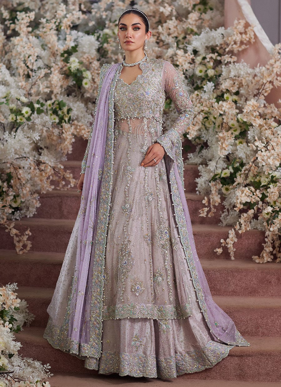 Farah Talib Aziz Elanur lilac bridal kalidaar crafted on pure net with intricate hand embellishments featuring a flared silhouette, paired with a classic lehenga and coordinated net dupatta with subtle embroidery, perfect for wedding festivities and formal celebrations.