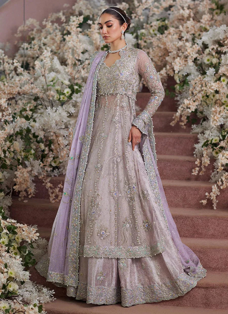Farah Talib Aziz Elanur lilac bridal kalidaar crafted on pure net with intricate hand embellishments featuring a flared silhouette, paired with a classic lehenga and coordinated net dupatta with subtle embroidery, perfect for wedding festivities and formal celebrations.