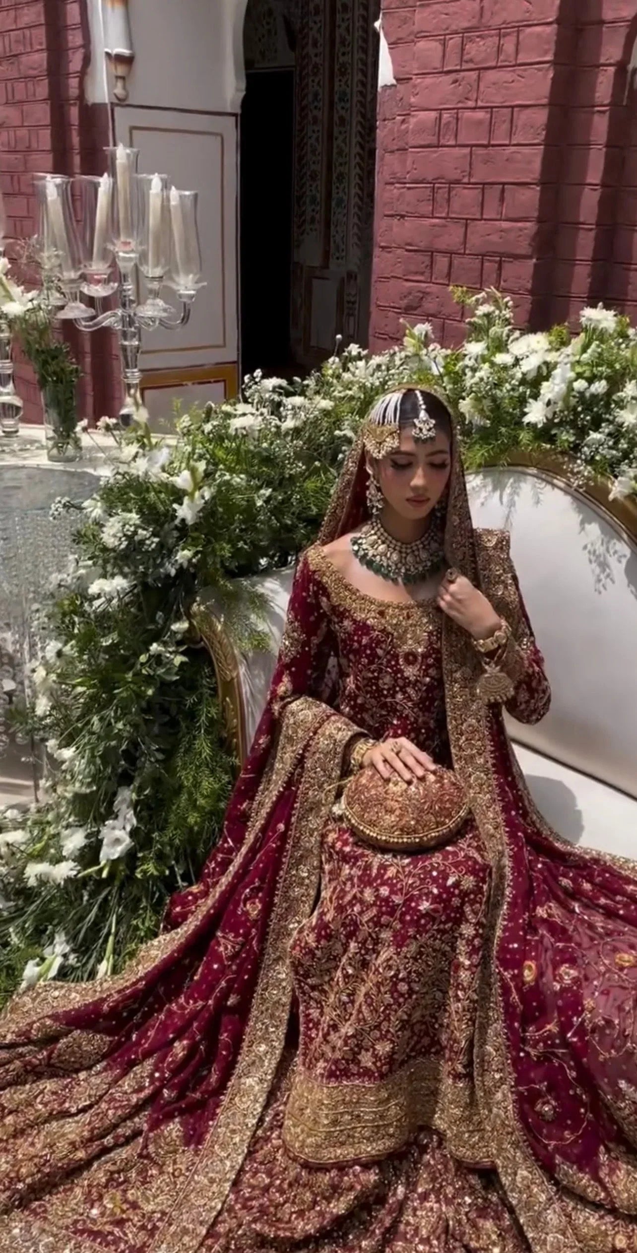 Haris Shakeel Ishq Series bridal ensemble in deep romantic maroon featuring intricate adda work and hand embellishment with fine dabka and handworked motifs spread generously across the shirt, sleeves, and flowing lehenga with richly embellished borders, paired with a heavily worked dupatta with ornate edging, perfect for brides seeking classic sophistication and traditional grandeur.