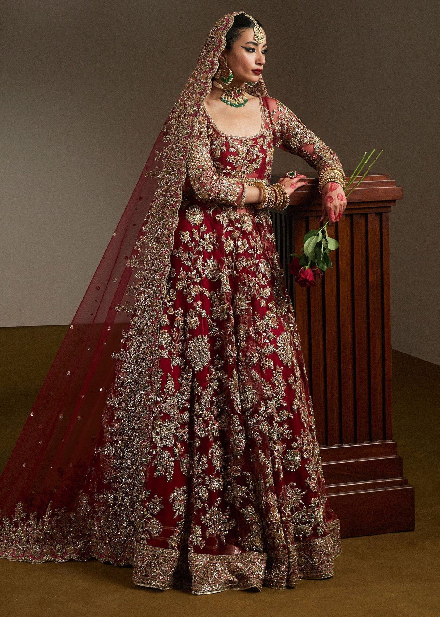Hussain Rehar Qashqaye deep maroon lehenga choli featuring exquisite handwork that shimmers with delicate light, with a voluminous lehenga paired with an intricately worked choli, perfect for bridal wear and grand wedding celebrations.