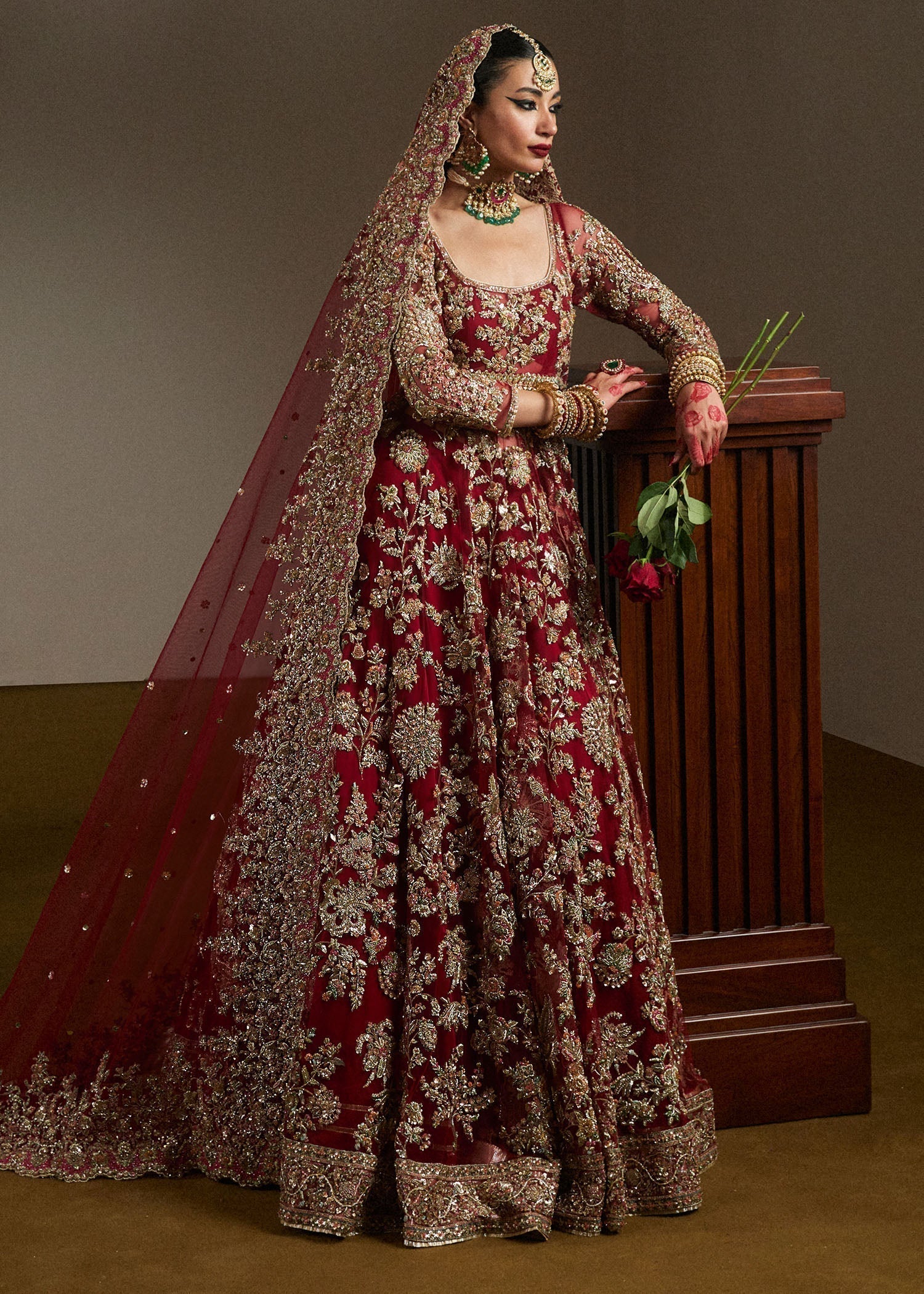 Hussain Rehar Qashqaye deep maroon lehenga choli featuring exquisite handwork that shimmers with delicate light, with a voluminous lehenga paired with an intricately worked choli, perfect for bridal wear and grand wedding celebrations.
