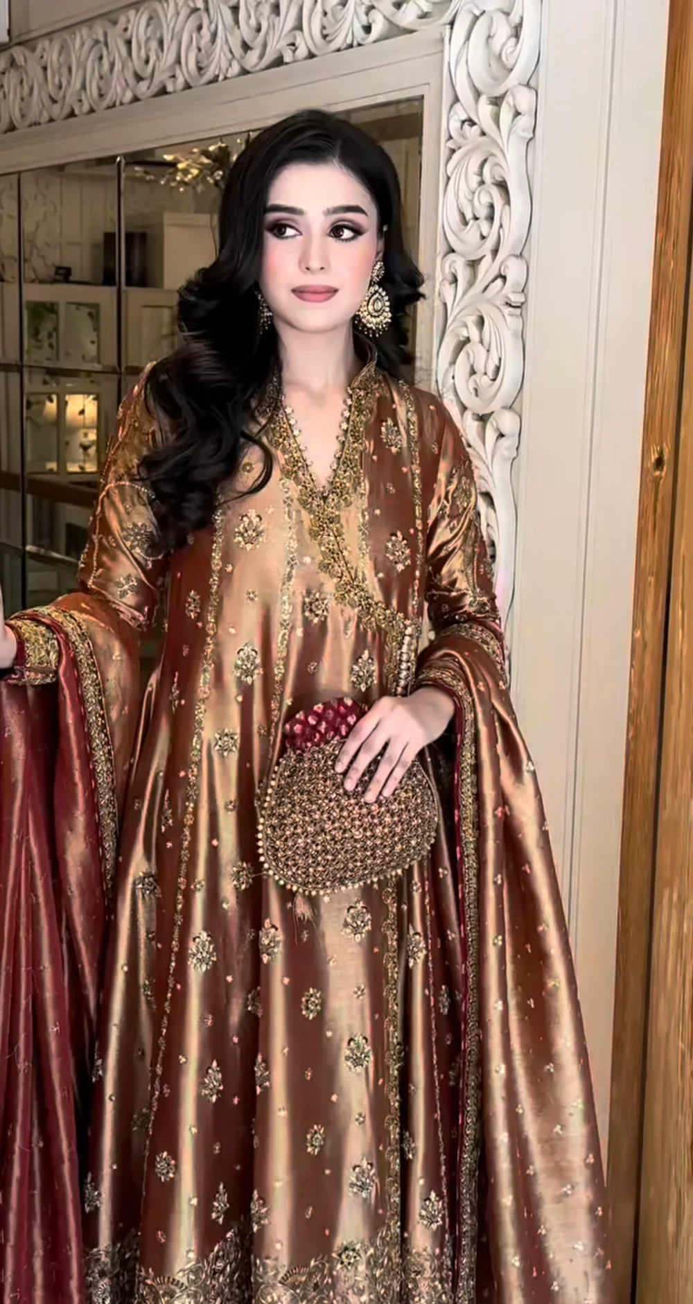 Haris Shakeel Aswad bronze-gold formal ensemble featuring intricate hand embellishments with detailed floral motifs, delicate sequins, and refined accents on an elongated silhouette with a heavily worked hemline, perfect for weddings, receptions, formal dinners, and festive celebrations.