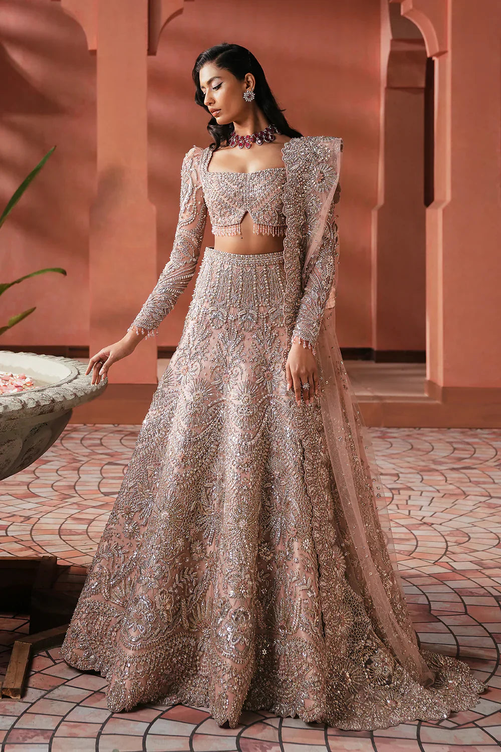 Soraya Catherine soft pink net bridal lehenga choli featuring intricate handwork with sparkling crystals, classic dabka embroidery, fine katdana detailing, and traditional mukesh work on a delicately embellished lehenga, paired with a matching net dupatta with coordinated detailing, perfect for wedding ceremonies, nikkah, and bridal receptions.