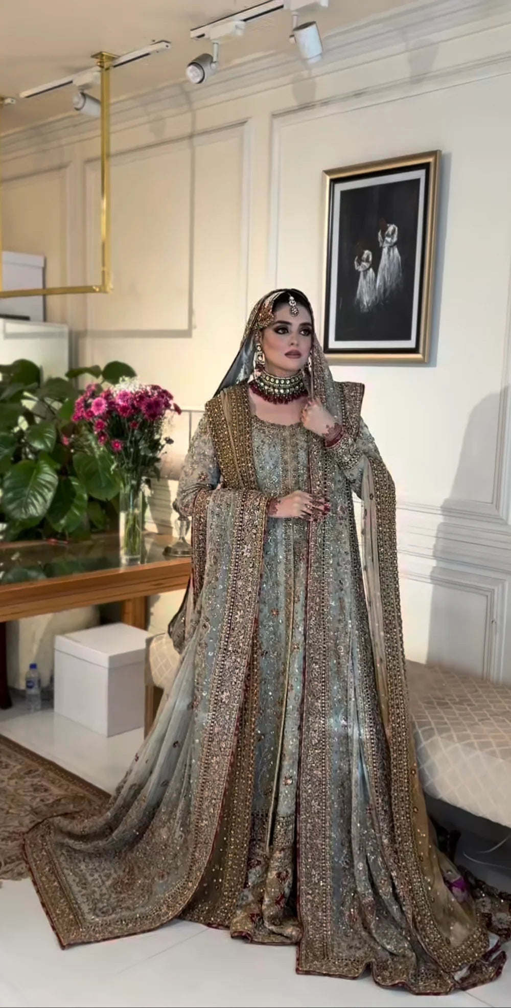 This beautiful ensemble features a richly detailed chiffon kurta adorned with delicate dabka and sitara hand embroidery. The premium malai‑lined kurta provides comfort while enhancing the luxurious feel, and the traditional gharara adds graceful volume and movement to your silhouette