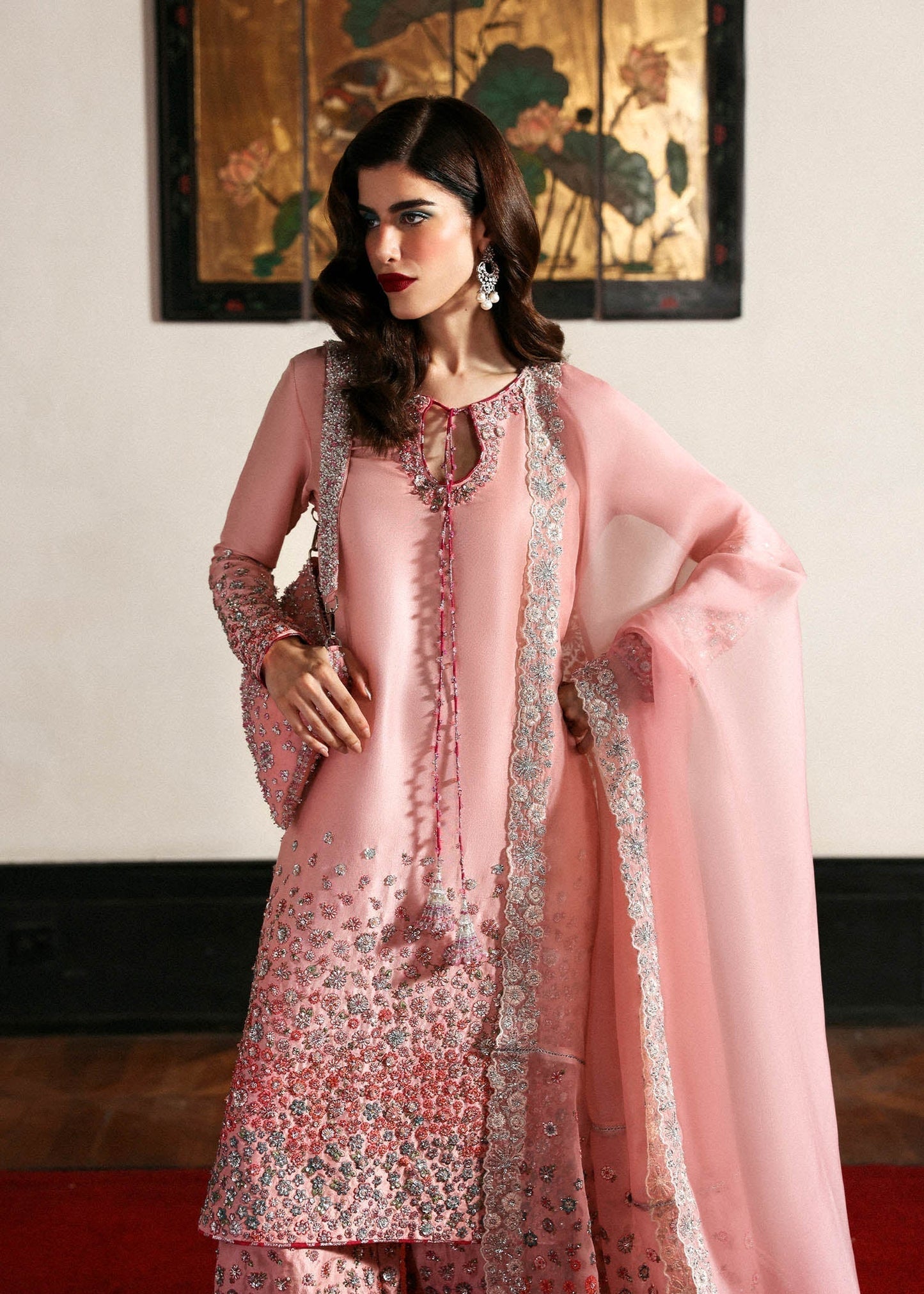 Hussain Rehar Evara ensemble featuring intricate embellishments with refined detail on rich flowing fabric in a statement silhouette with bold accents and a perfectly tailored cut, paired with a graceful dupatta, perfect for weddings and formal occasions.