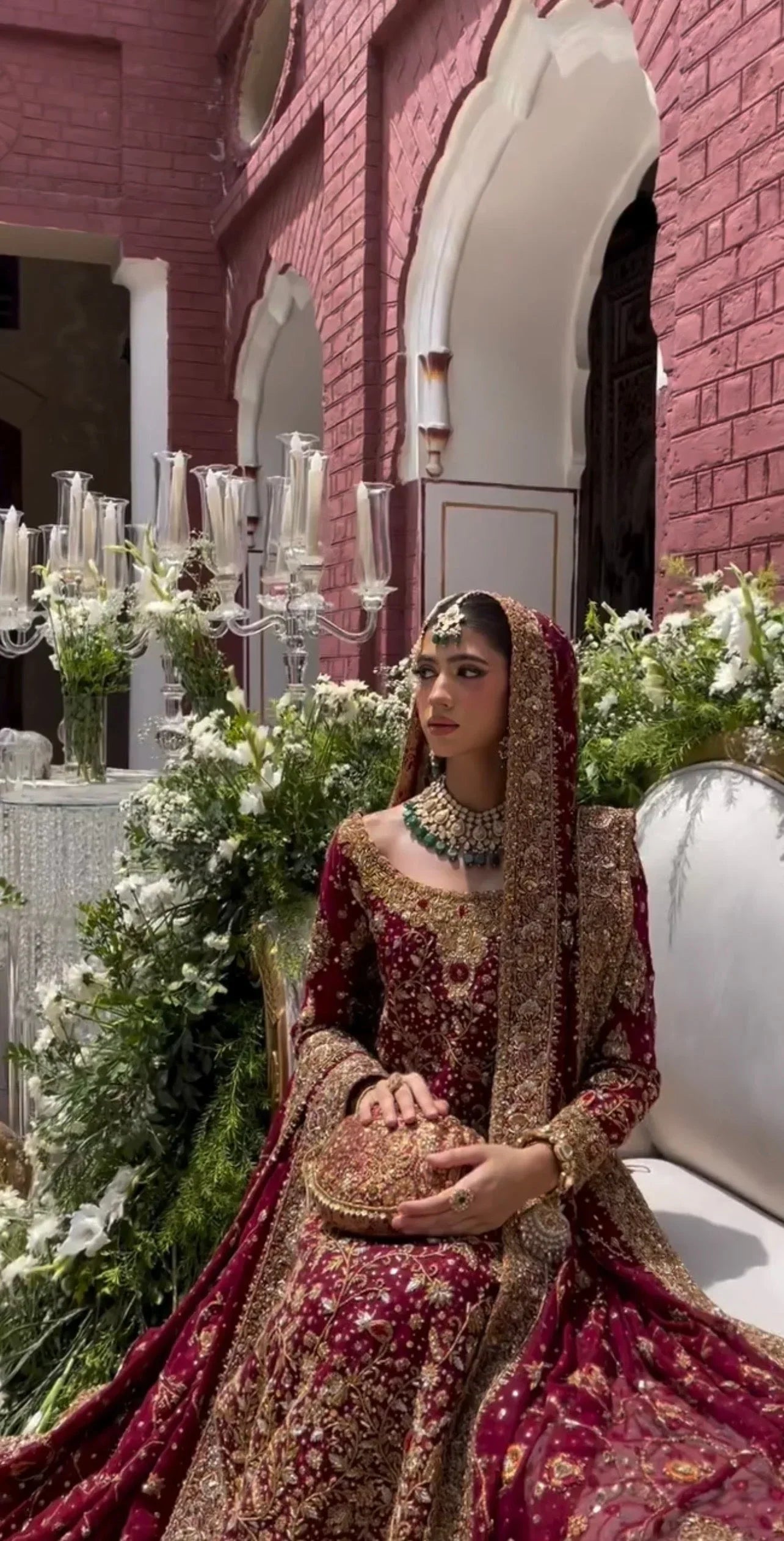 Haris Shakeel Ishq Series bridal ensemble in deep romantic maroon featuring intricate adda work and hand embellishment with fine dabka and handworked motifs spread generously across the shirt, sleeves, and flowing lehenga with richly embellished borders, paired with a heavily worked dupatta with ornate edging, perfect for brides seeking classic sophistication and traditional grandeur.