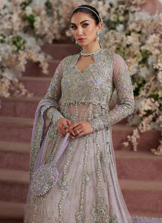 Farah Talib Aziz Elanur lilac bridal kalidaar crafted on pure net with intricate hand embellishments featuring a flared silhouette, paired with a classic lehenga and coordinated net dupatta with subtle embroidery, perfect for wedding festivities and formal celebrations.