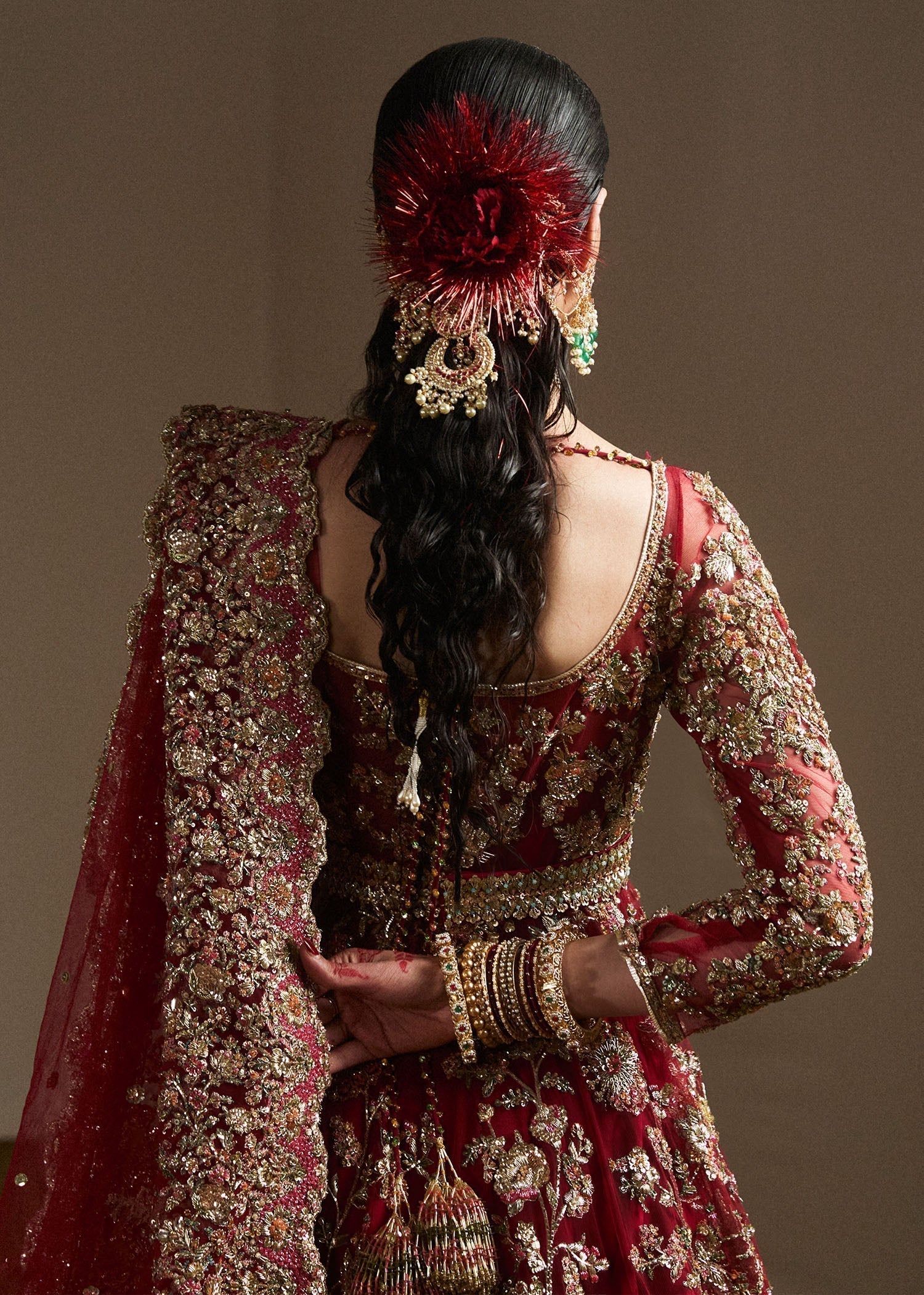 Hussain Rehar Qashqaye deep maroon lehenga choli featuring exquisite handwork that shimmers with delicate light, with a voluminous lehenga paired with an intricately worked choli, perfect for bridal wear and grand wedding celebrations.
