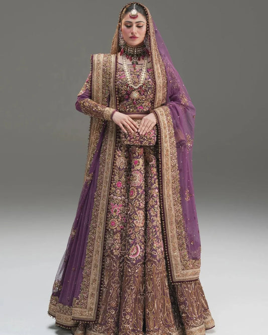 Fahad Hussayn Mirbail wine net lehenga choli featuring a structured corset-style blouse with intricate embroidery and handwork embellishments, paired with a flowing net lehenga in rich wine color and a lightweight net dupatta with an exquisitely embellished border, perfect for bridal wear, weddings, receptions, and festive celebrations.