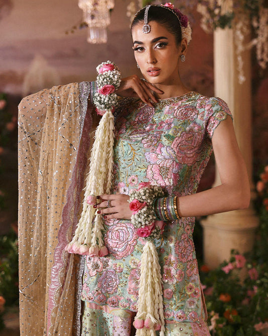 Nomi Ansari Fairytale pastel bridal lehenga choli featuring a harmonious blend of blush pink, powder blue, and pistachio tones with intricate hand embroidery, delicate zari work, and shimmering embellishments on a beautifully panelled lehenga with a finely embellished choli and a dreamy net dupatta with subtle detailing, perfect for valima, engagement, nikah, and reception events.