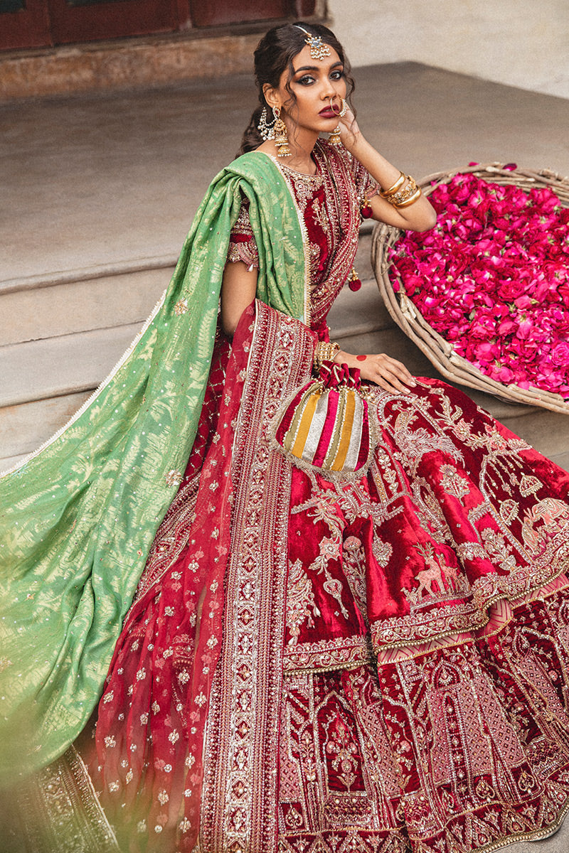 Mohsin Naveed Ranjha MNR HR-71 sindoori red raw silk bridal ensemble featuring a half-sleeved boat neck choli with hand-embellished motifs, worn with a two-tiered lehnga doused in signature Mughal miniature patterns, complete with a chan booti dupatta and a hand-loomed cotton net jamawar shawl, Pakistani luxury wedding formal wear.
