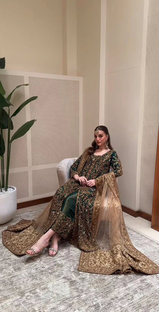 Haris Shakeel ZD-01 emerald heirloom ensemble in deep emerald green featuring intricate antique gold embroidery with dense hand-embellished motifs on a long flowing silhouette, paired with a richly detailed dupatta with heavy borders and delicate shimmer, perfect for bridal elegance and timeless sophistication.