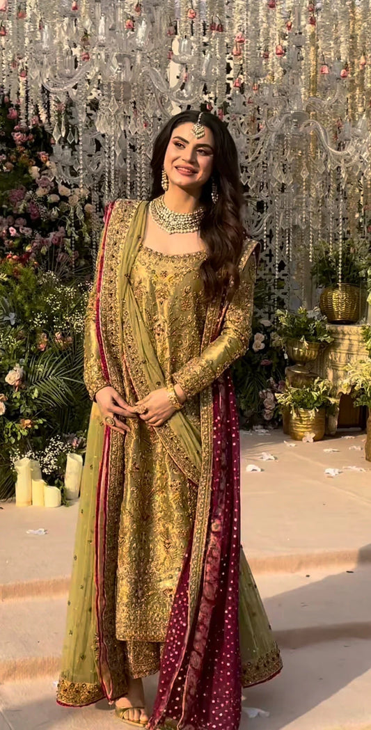 Haris Shakeel inspired pistachio green festive ensemble featuring a shirt with intricate embroidery and delicate embellishments creating a refined luminous texture, paired with a coordinated dupatta with rich contrasting borders and straight-cut trousers, perfect for wedding festivities, formal gatherings, and celebratory occasions.