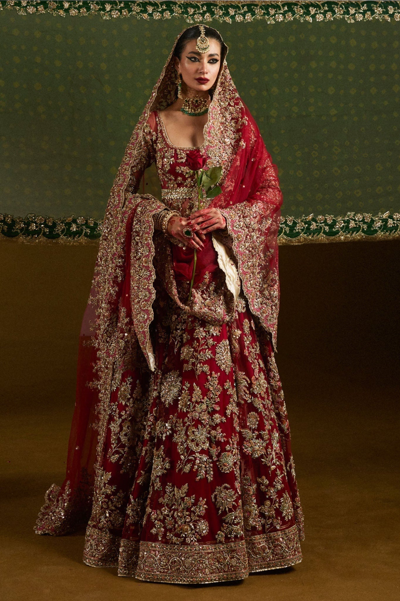 Hussain Rehar Qashqaye deep maroon lehenga choli featuring exquisite handwork that shimmers with delicate light, with a voluminous lehenga paired with an intricately worked choli, perfect for bridal wear and grand wedding celebrations.