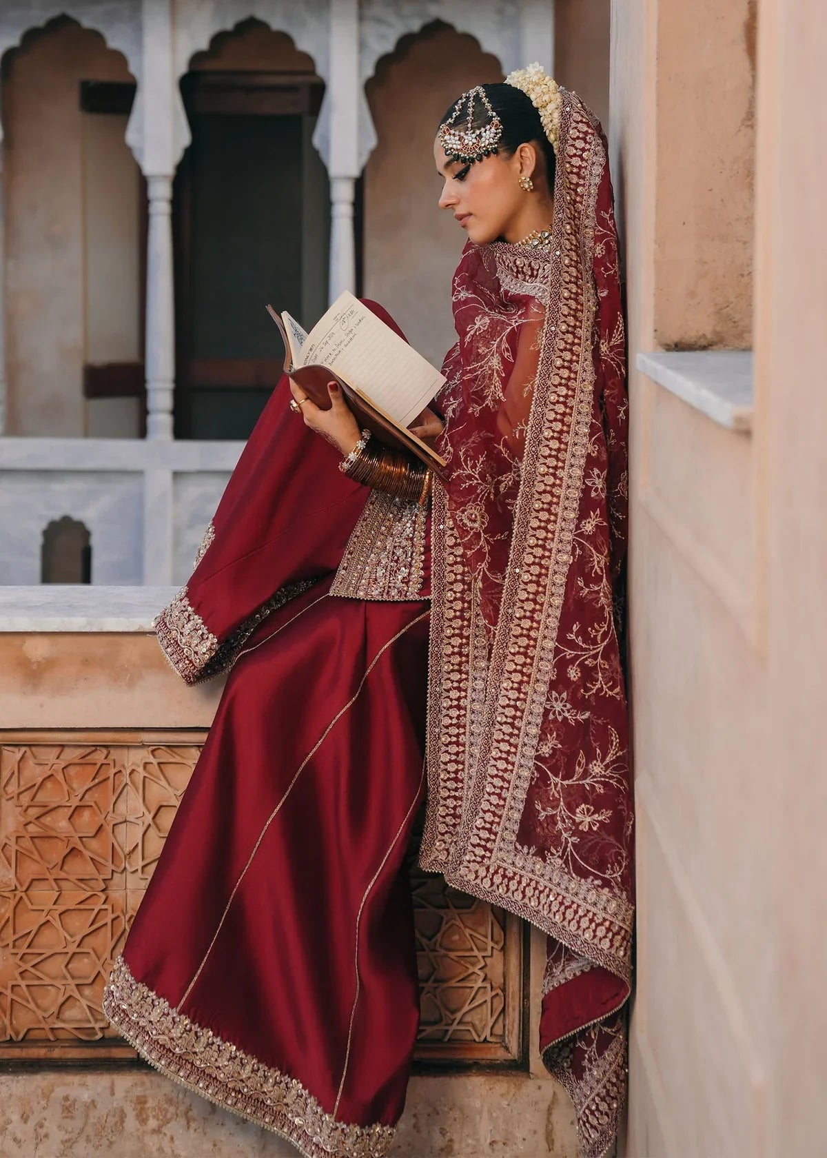 Mehek red ada embroidery Pakistani formal three-piece ensemble featuring a tissue silk shirt with a square neckline and intricate traditional embroidery, paired with matching tissue silk gharara and a kathan organza dupatta, perfect for weddings and festive celebrations.