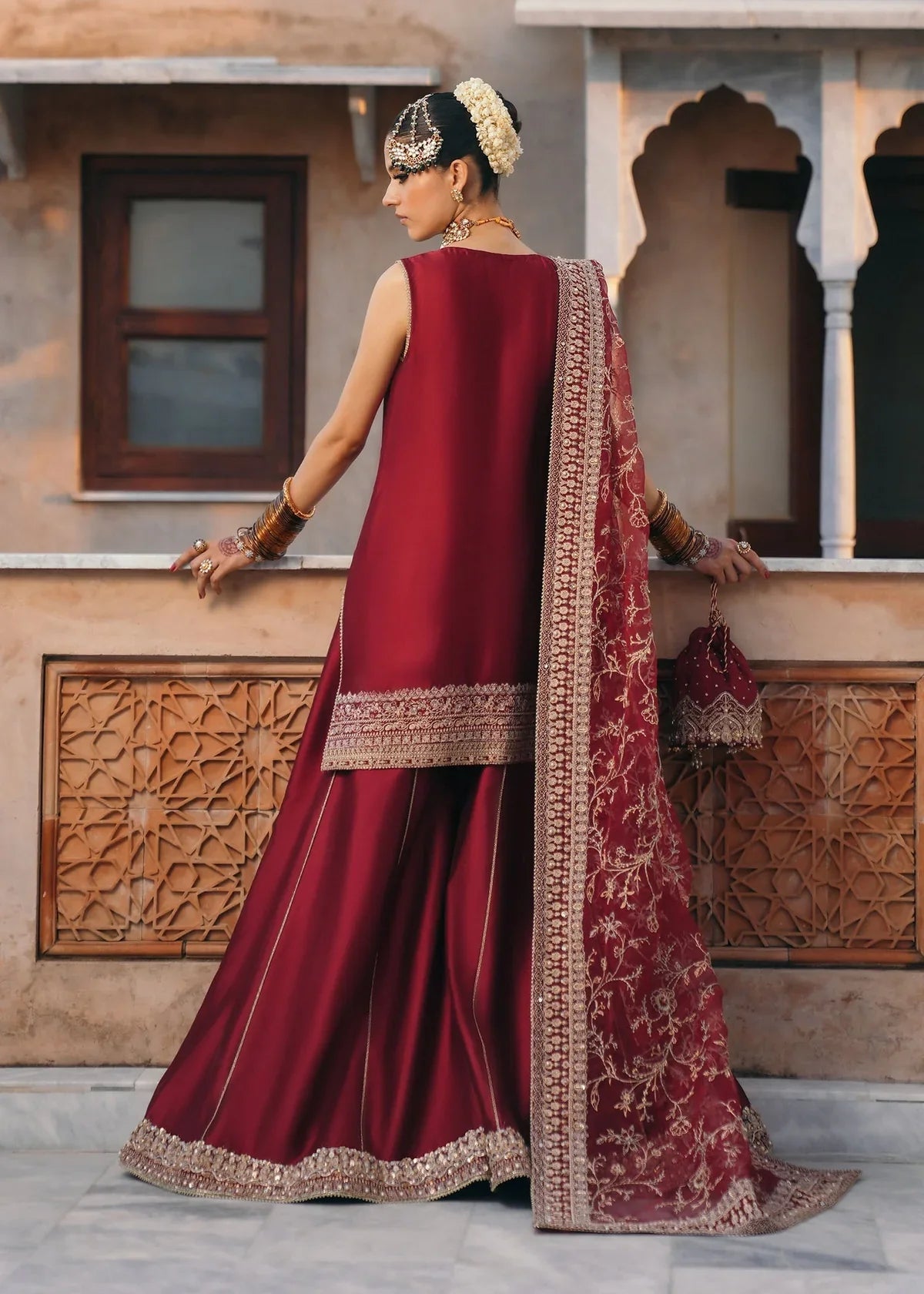 Mehek red ada embroidery Pakistani formal three-piece ensemble featuring a tissue silk shirt with a square neckline and intricate traditional embroidery, paired with matching tissue silk gharara and a kathan organza dupatta, perfect for weddings and festive celebrations.