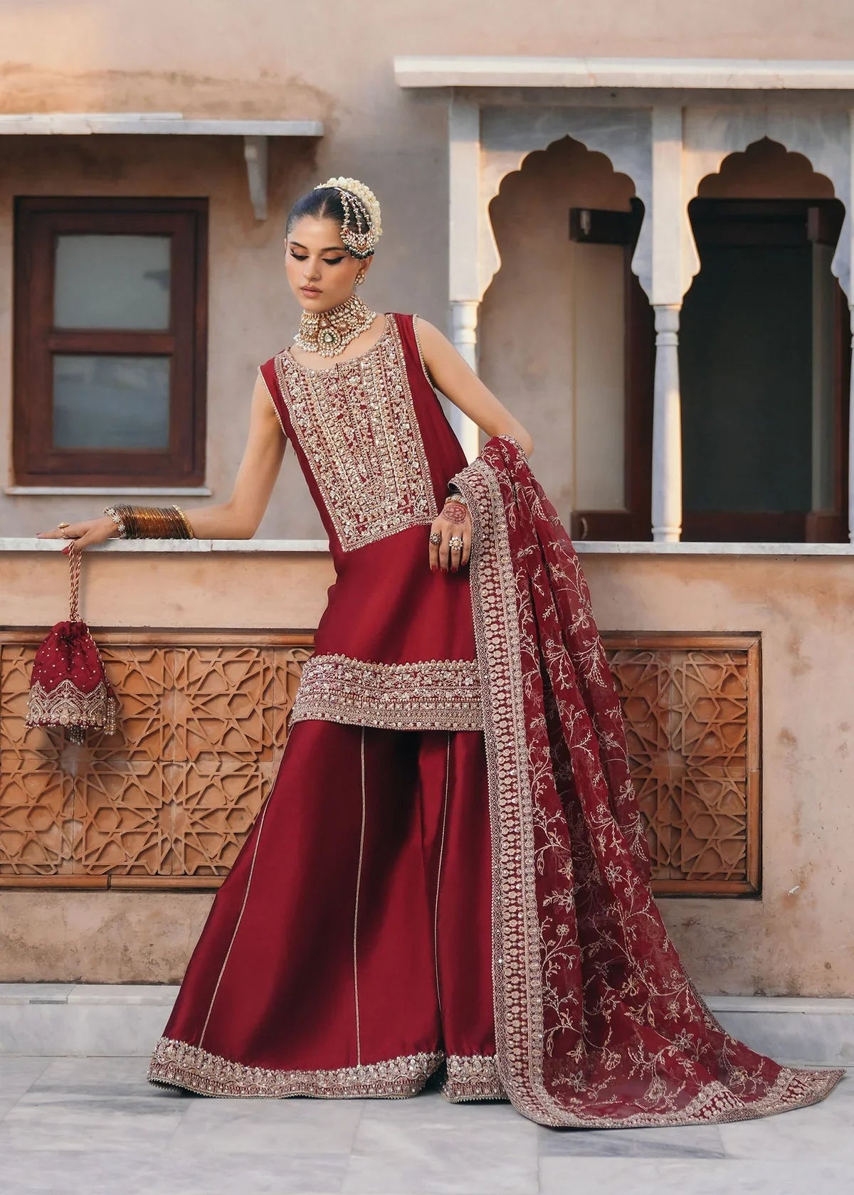 Mehek red ada embroidery Pakistani formal three-piece ensemble featuring a tissue silk shirt with a square neckline and intricate traditional embroidery, paired with matching tissue silk gharara and a kathan organza dupatta, perfect for weddings and festive celebrations.