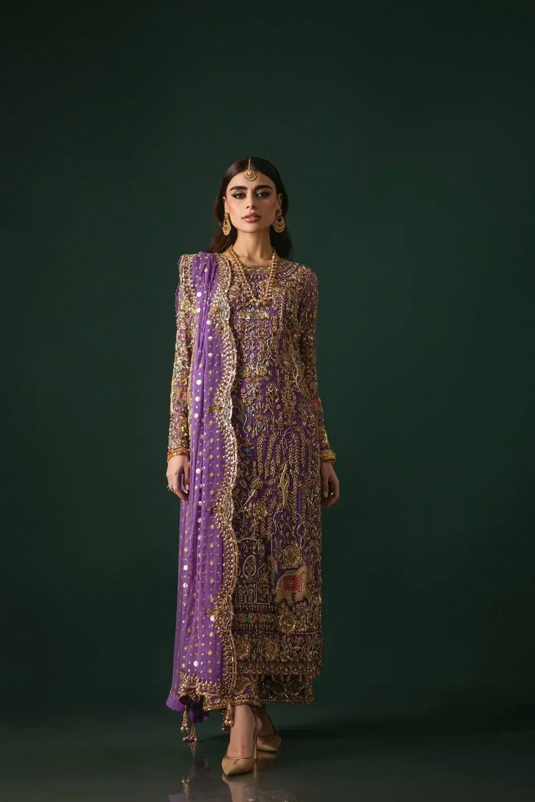 Nomi Ansari Amara Luxe rich purple formal ensemble featuring heavy hand embellishments with a harmonious blend of floral and animal-inspired patterns, bejeweled detailing, fine bordered ezaar work, and a long flowing dupatta with intricate cutwork, perfect for weddings, receptions, and festive celebrations.