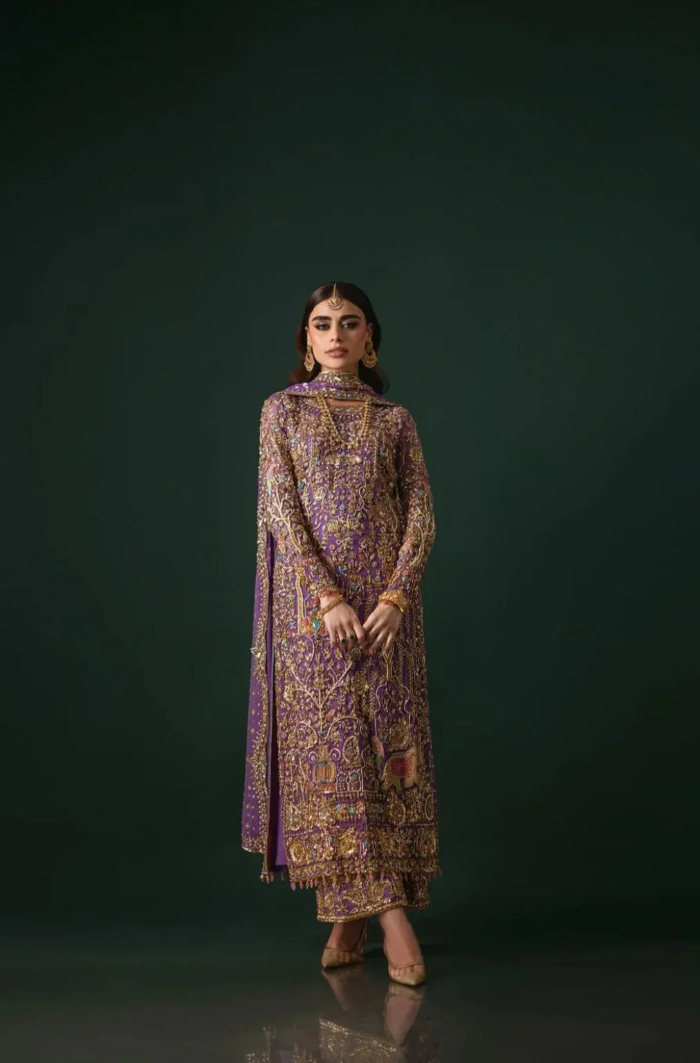 Nomi Ansari Amara Luxe rich purple formal ensemble featuring heavy hand embellishments with a harmonious blend of floral and animal-inspired patterns, bejeweled detailing, fine bordered ezaar work, and a long flowing dupatta with intricate cutwork, perfect for weddings, receptions, and festive celebrations.