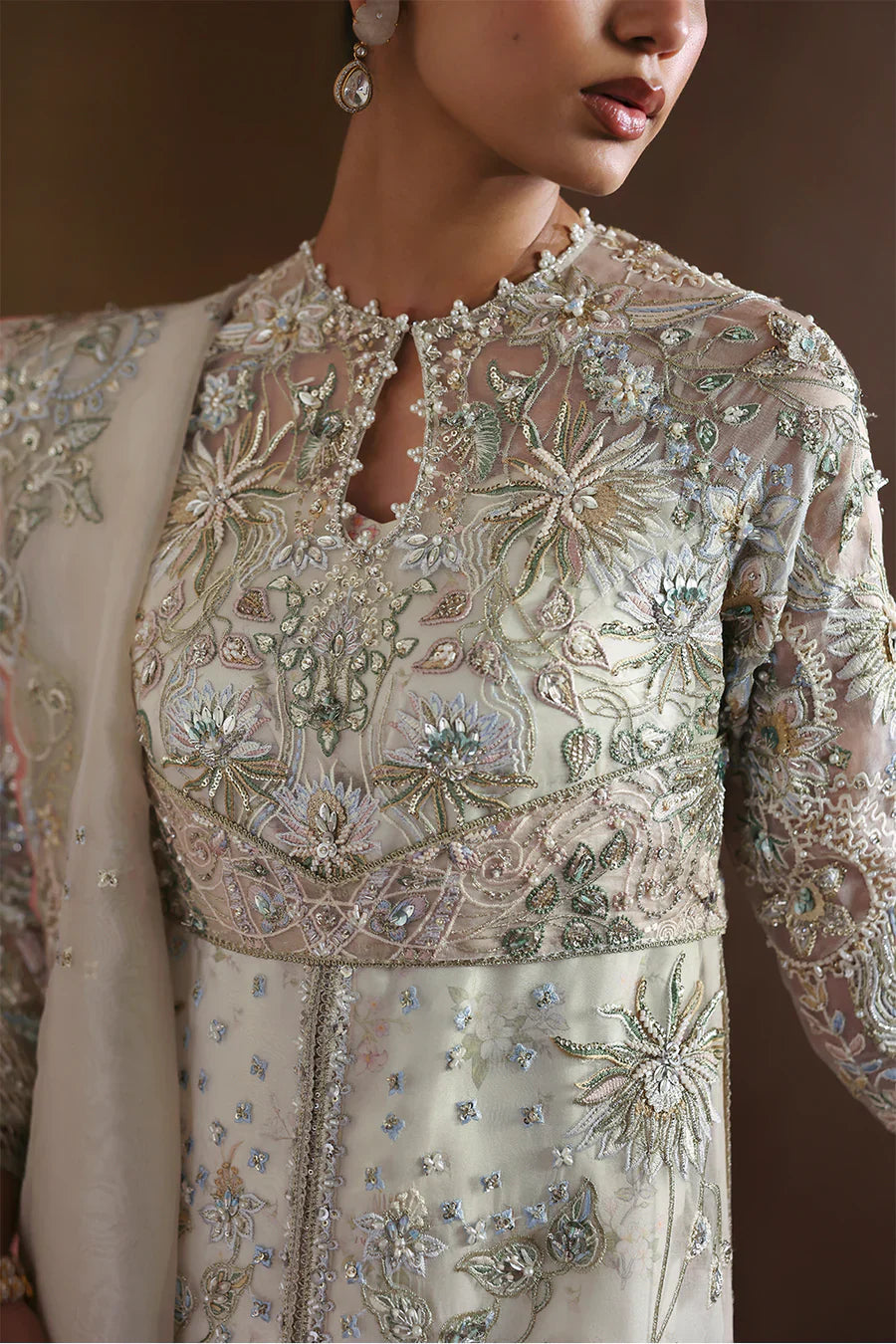Soraya Novara ivory and gold formal ensemble featuring a beautifully embellished shirt with intricate handwork blending delicate thread embroidery, shimmering sequins, and fine embellishments on a soft ivory base with detailed gold accents, paired with a complementing dupatta, perfect for weddings, receptions, engagement ceremonies, and festive celebrations.