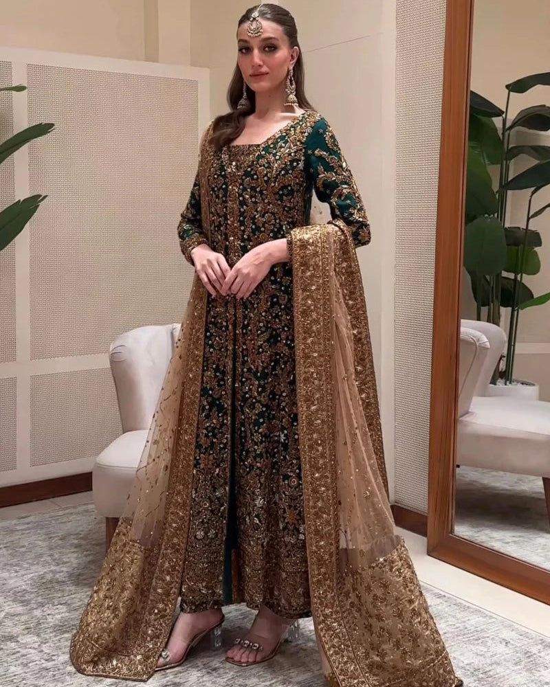 Haris Shakeel ZD-01 emerald heirloom ensemble in deep emerald green featuring intricate antique gold embroidery with dense hand-embellished motifs on a long flowing silhouette, paired with a richly detailed dupatta with heavy borders and delicate shimmer, perfect for bridal elegance and timeless sophistication.
