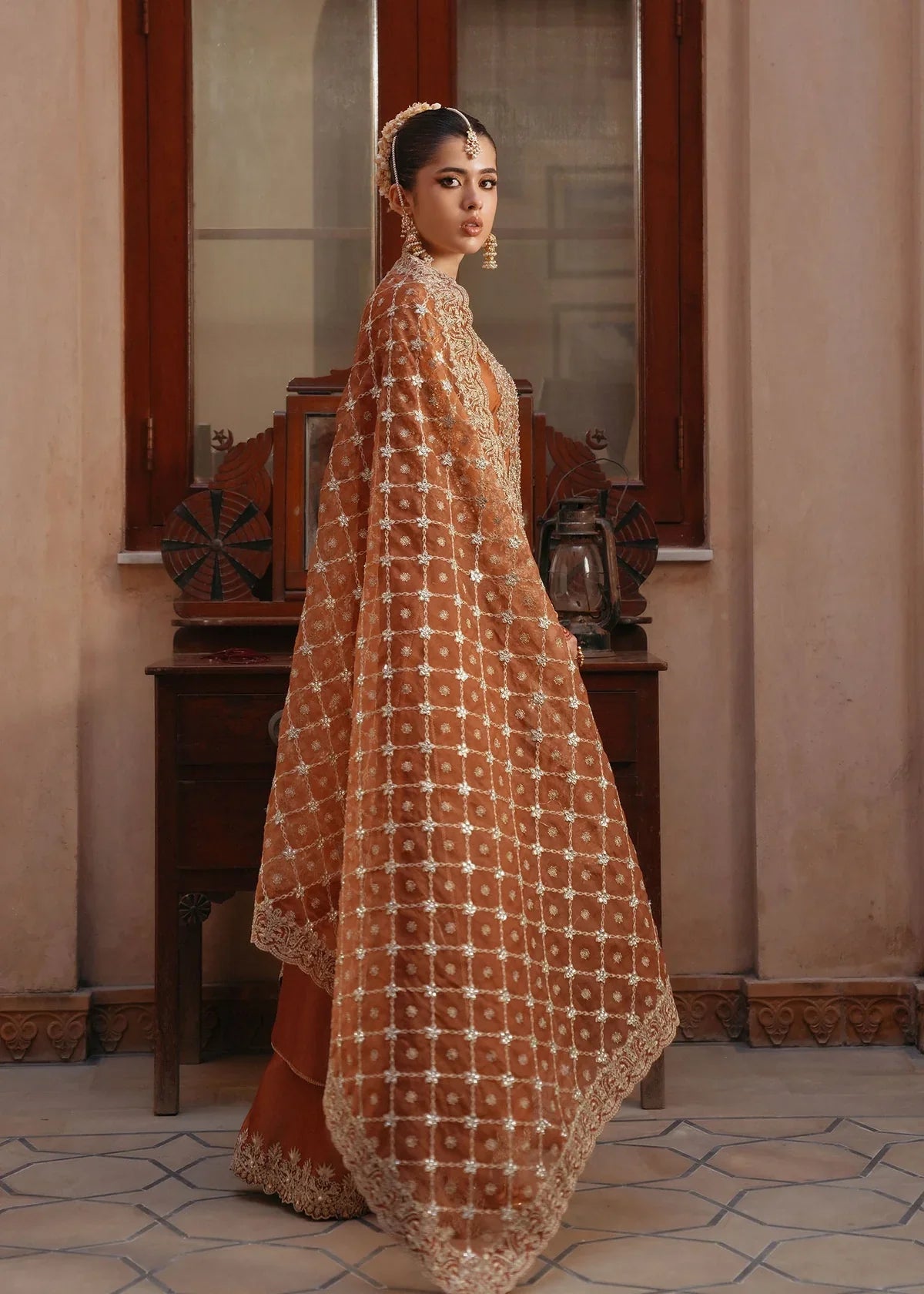 Zulekha Golden Mocha Pakistani formal three-piece ensemble featuring a long shirt in luxurious Korean silk with delicate embroidery on the neckline and sleeves, paired with matching flared trousers and a fully embroidered organza dupatta, perfect for festive evenings and elegant gatherings.