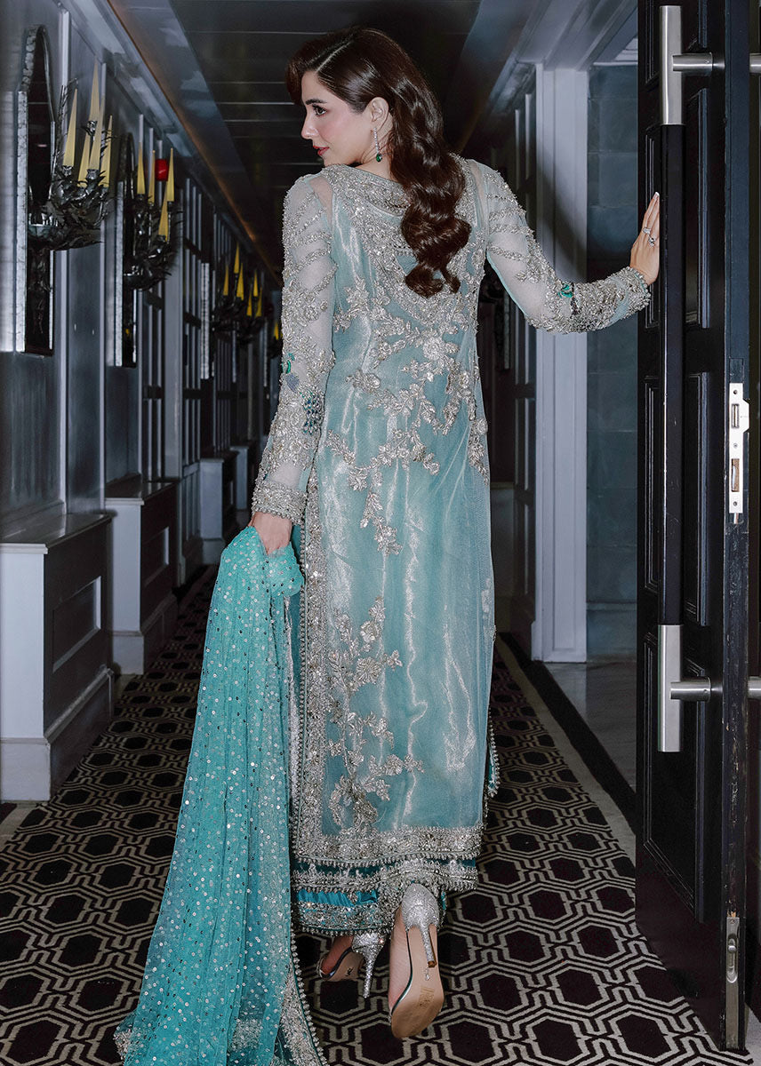 Sara Rohale Asghar Ferozeah aqua long shirt featuring intricate silver embellishments with hand-embroidered floral motifs creating a refined jal, paired with a sheer dupatta with heavily embellished border and scattered sequins, and straight-cut azar trousers with bejeweled peacock hem in silver threadwork, perfect for formal occasions and statement looks.